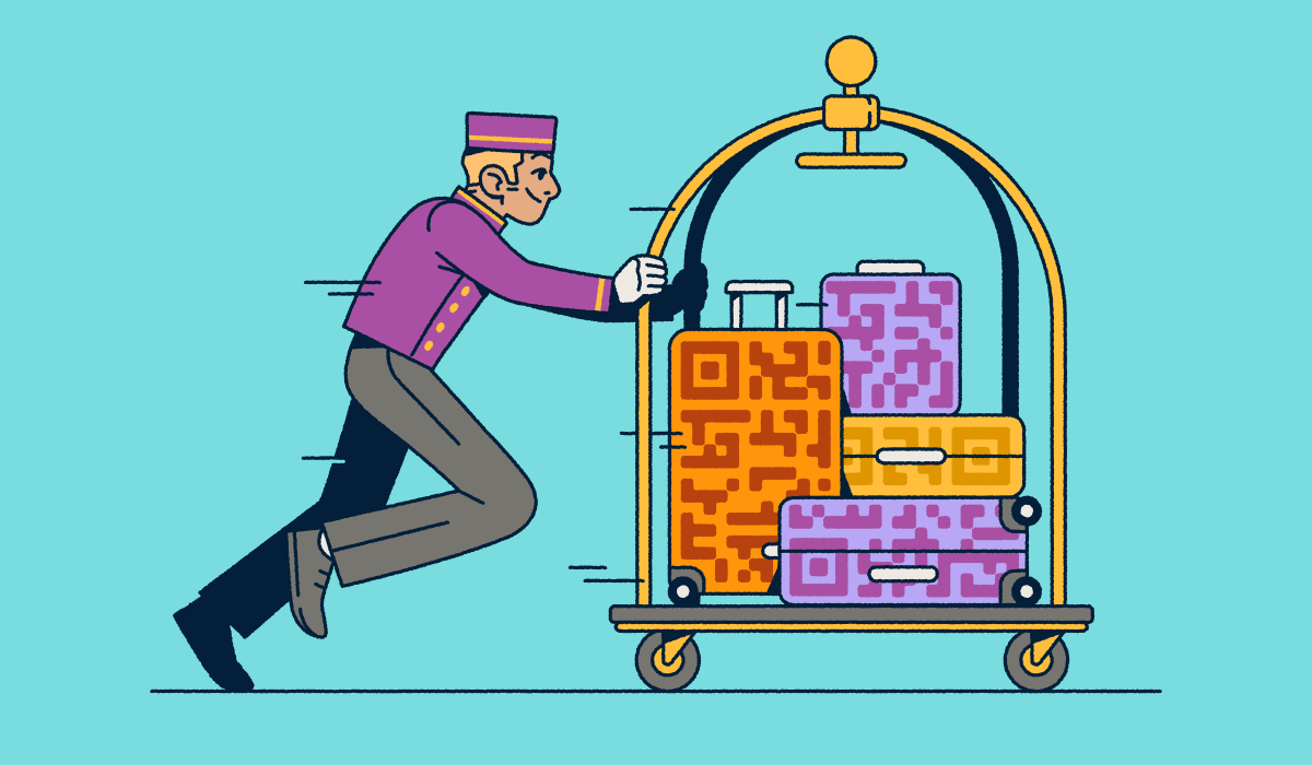 A bellhop pushing a luggage cart with several suitcases that have QR Code prints on them.
