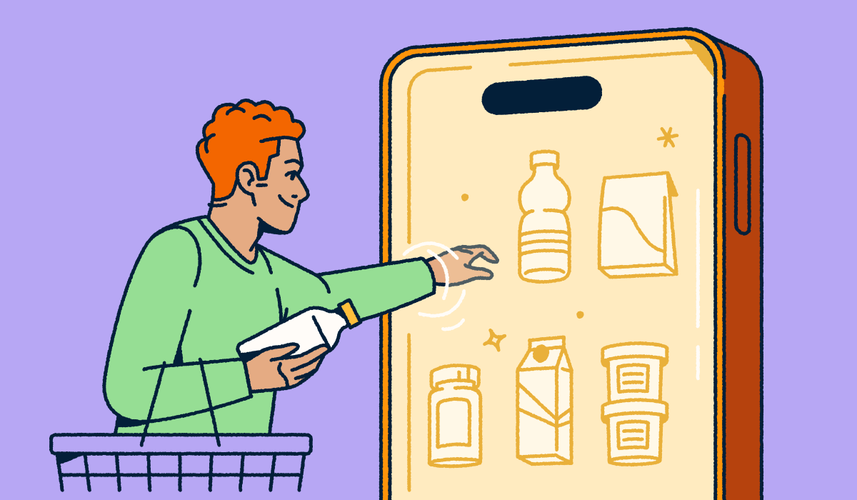 A person holding a shopping basket and selecting consumer packaged goods from a mobile "fridge."